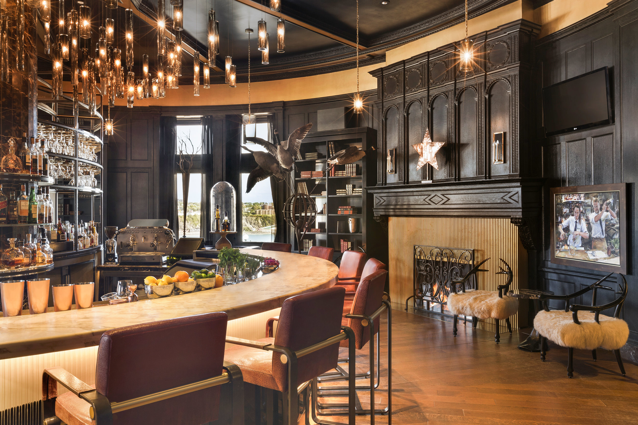 bar with dark wood walls and fireplace