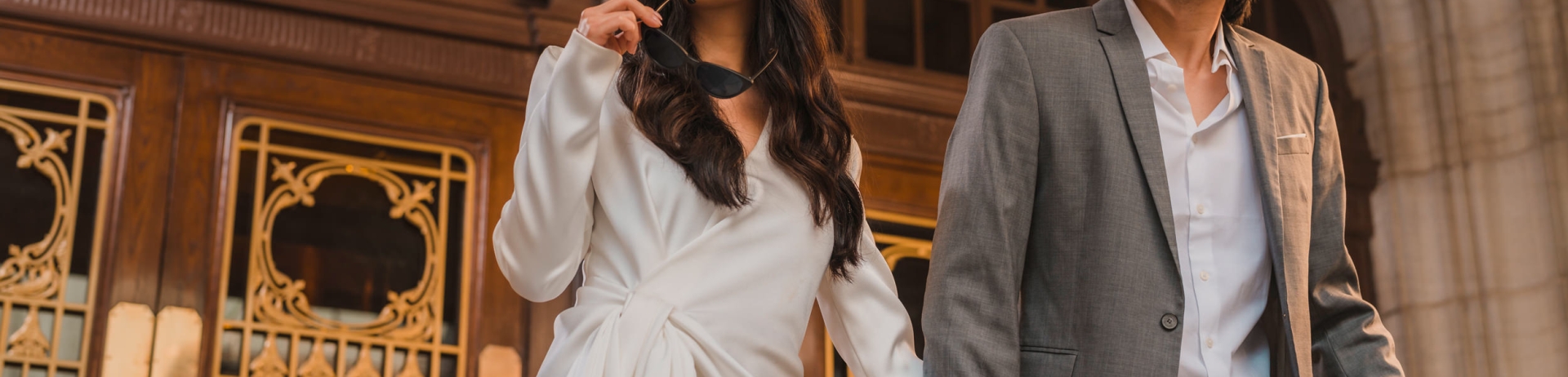 a couple holding hands exiting the building