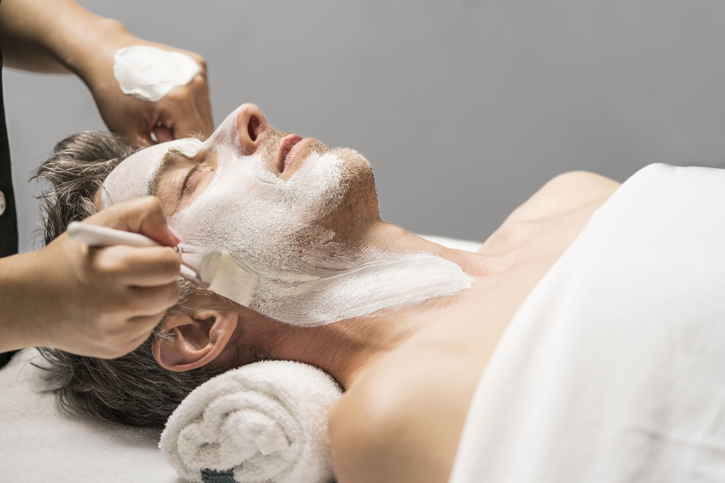 man getting a mask painted on face