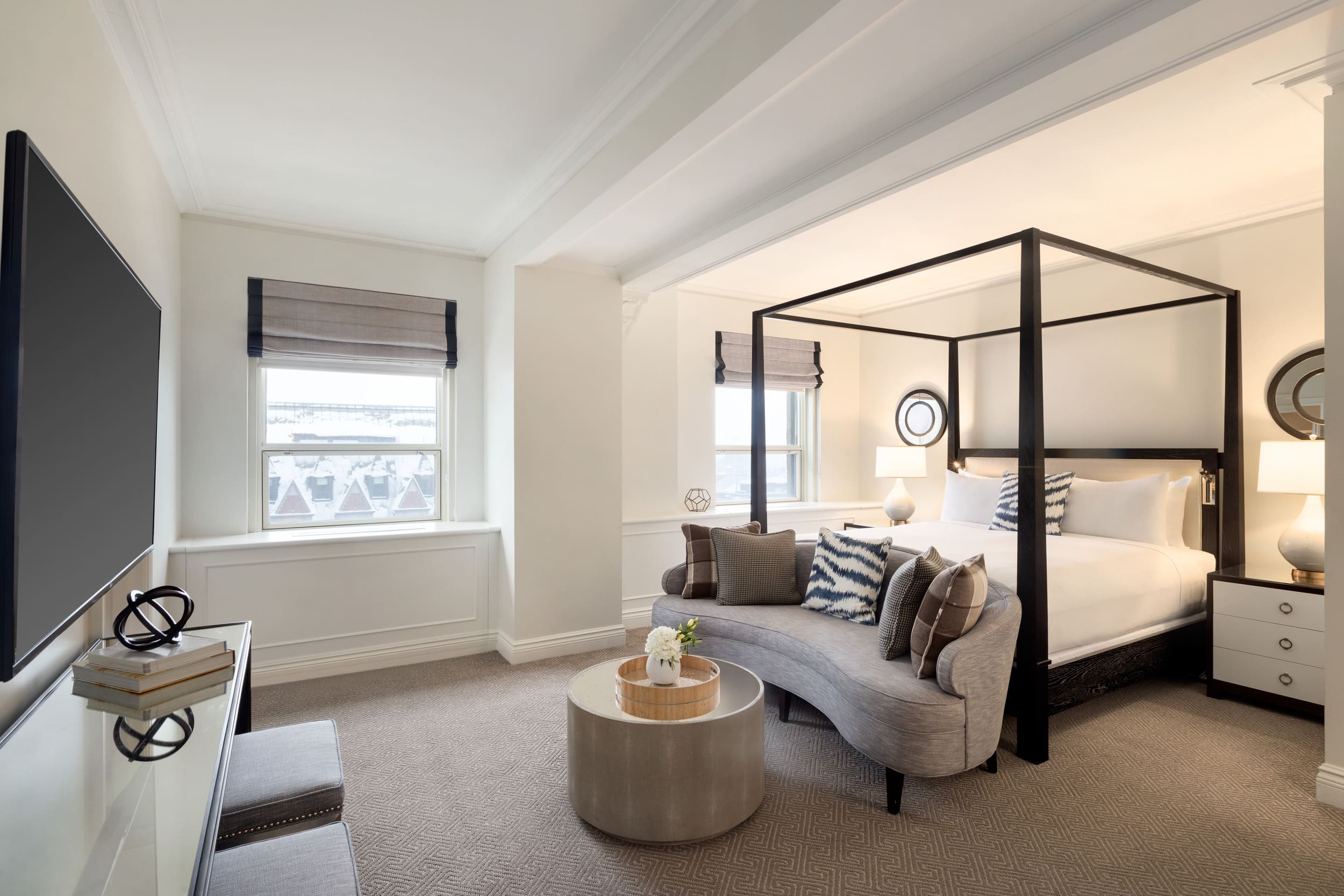 bedroom with couch in at foot of bed
