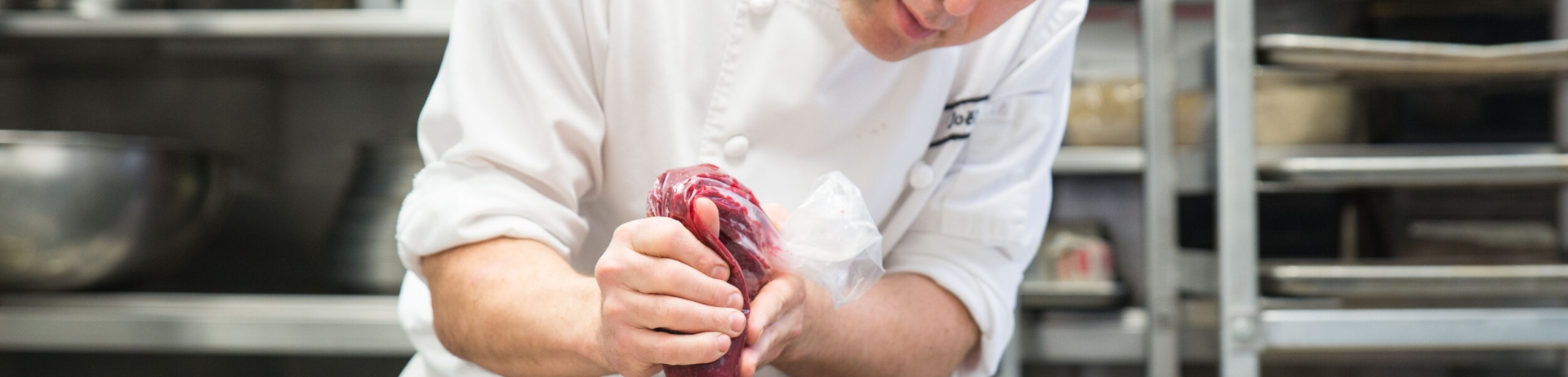 chef joel adding frosting to small dessert dish