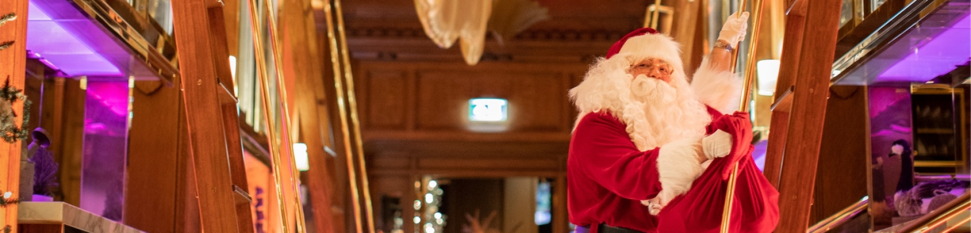 Santa on a ladder in a hallway