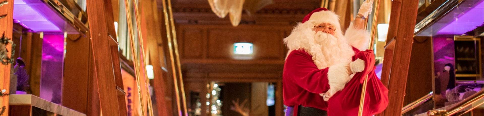 Santa on a ladder in a hallway